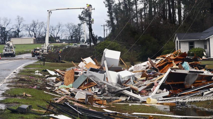 The remains of a house sit in a debris pile along Highway 122 as power line workers repair a downed line Sunday, January 22, 2017, near Barney, Georgia. The National Weather Service said Sunday that southern Georgia, northern Florida and the corner of southeastern Alabama could face "intense and long track" tornadoes, scattered damaging winds and large hail. 