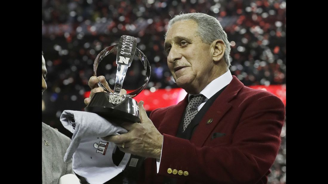Atlanta Falcons owner Arthur Blank holds the George Halas Trophy after the NFC championship. The Falcons beat the Green Bay Packers 44-21 to advance to Super Bowl LI, where they will play the New England Patriots.