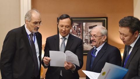 Syrian chief delegate Bashar al-Jaafari, left, with Kazakhstan Foreign Minister Kairat Abdrakhmanov, to his left, on Sunday ahead of peace talks.