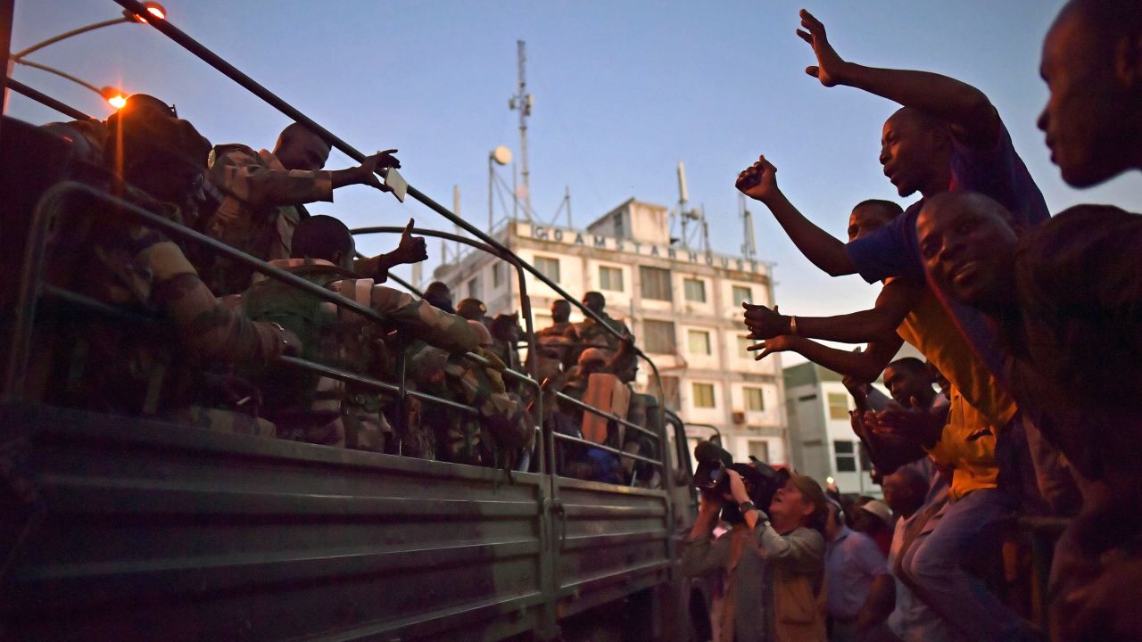 Citizens celebrate the arrival of troops after the former President Yahya Jammeh fled the country.