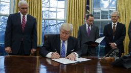 President Donald Trump signs an executive order to withdraw the U.S. from the 12-nation Trans-Pacific Partnership trade pact agreed to under the Obama administration, Monday, Jan. 23, 2017, in the Oval Office of the White House in Washington. (AP Photo/Evan Vucci)