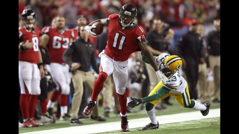 Atlanta wide receiver Julio Jones stiff-arms Damarious Randall on his way to a 73-yard touchdown on Sunday, January 22. Jones had 180 yards and two touchdowns in the Falcons' 44-21 win over Green Bay.