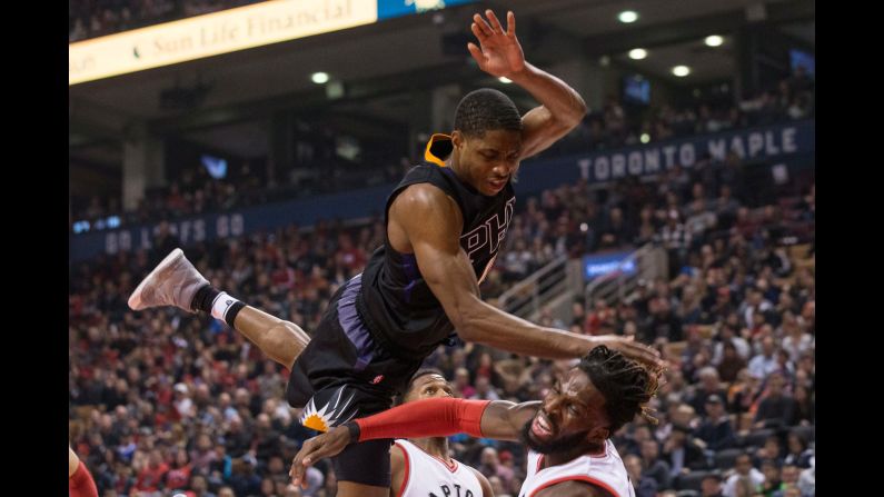 Phoenix's Brandon Knight, top, fouls Toronto's DeMarre Carroll during an NBA basketball game in Toronto on Sunday, January 22.