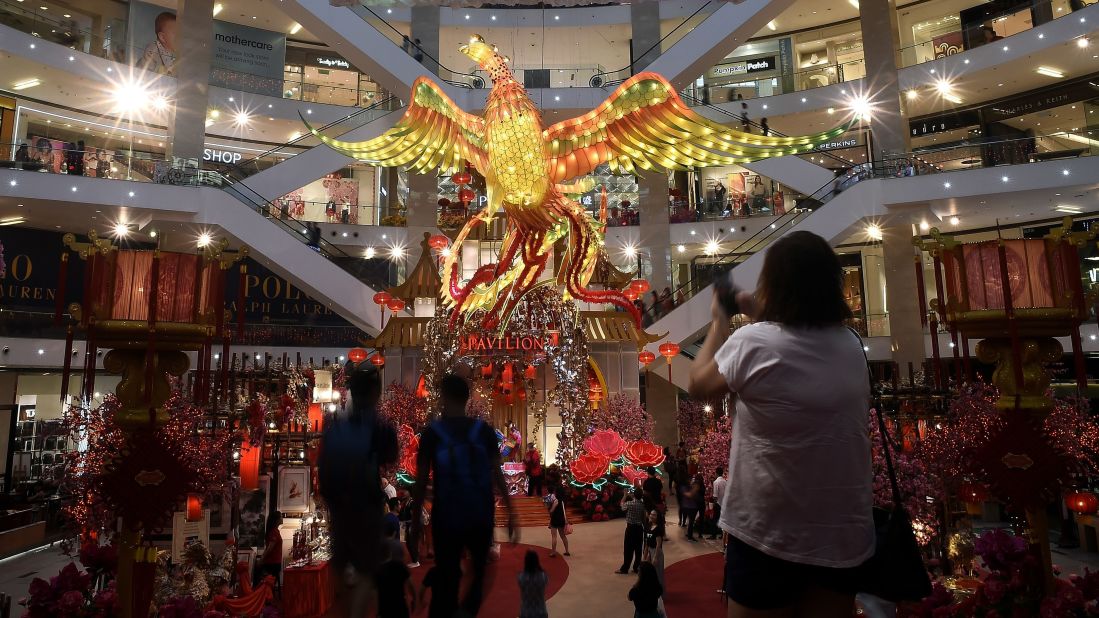 Visitors walk past a giant rooster installation at a shopping mall in Kuala Lumpur, Malaysia, on Wednesday, January 11. 
