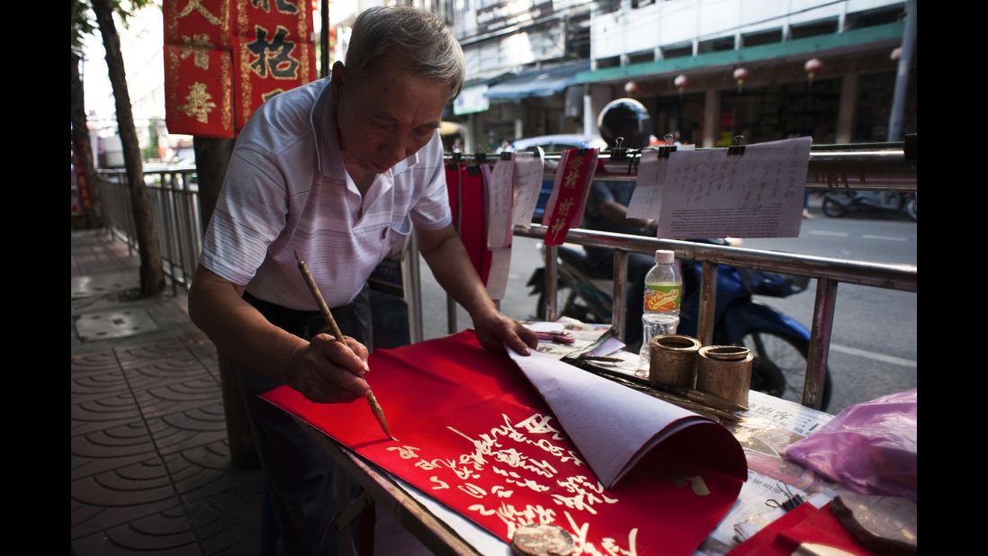 A calligrapher writes out New Year's greetings in Bangkok, Thailand, on Saturday, January 21.