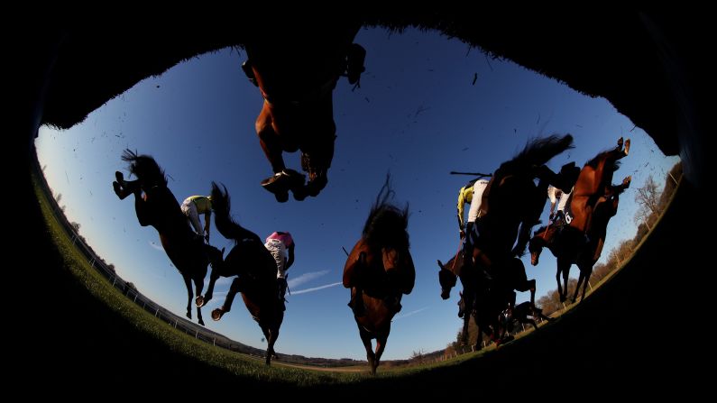 Horses jump over an obstacle during a steeplechase in Chepstow, Wales, on Friday, January 20.