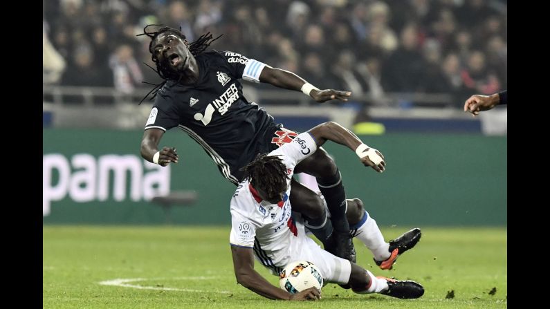 Marseille forward Bafetembi Gomis, top, is tackled by Lyon defender Mapou Yanga-Mbiwa during a French league match on Sunday, January 22.