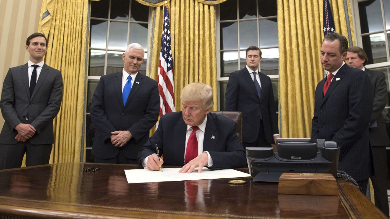 President Donald Trump prepares to sign a confirmation for Homeland Security Secretary James Kelly, in the Oval Office at the White House in Washington, D.C. on January 20, 2017. 