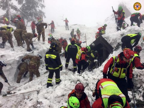 Italian rescuers and volunteers continue a rescue operation on Sunday, January 22 at the site of the avalanche that inundated Hotel Rigapiano.