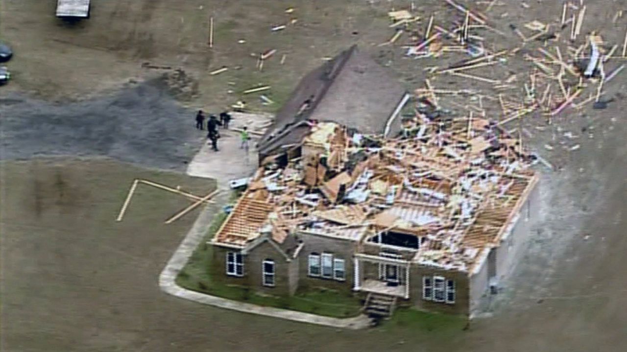 The tornado ripped through this home's roof and top level, strewing debris across the area.
