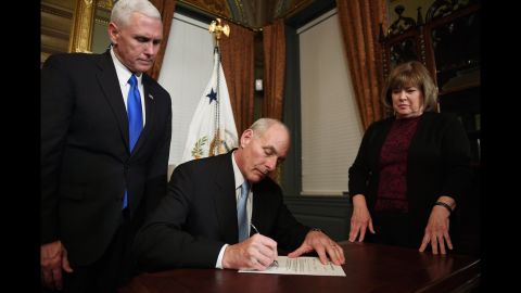 Retired Marine Gen. John Kelly signs his confirmation letter on January 20. He is joined by his wife, Karen.