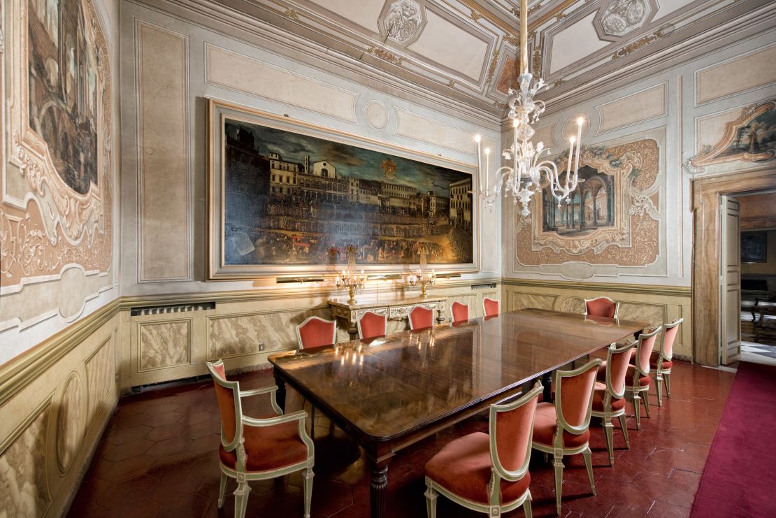 Oil paintings and rich velvet adorn the Residenza Ruspoli Bonaparte's dining room.