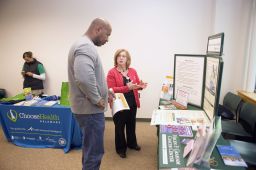 Cancer screening nurse navigator Charlene Marinelli of the Graham Cancer Center talks about colorectal cancer with a participant at an event geared toward men of color.