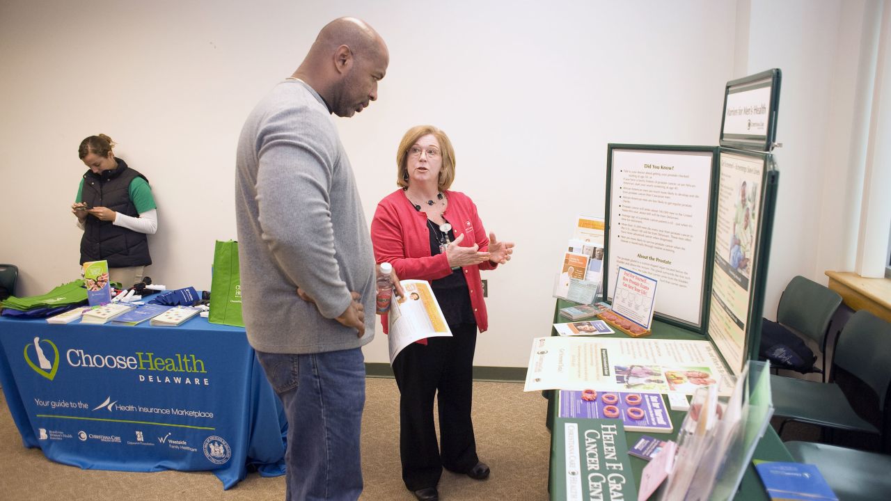 Cancer screening nurse navigator Charlene Marinelli of the Graham Cancer Center talks about colorectal cancer with a participant at an event geared toward men of color.