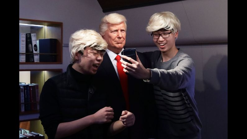 Two young men take a selfie with US President Donald Trump as they visit a wax museum in Seoul, South Korea, on Friday, January 20.