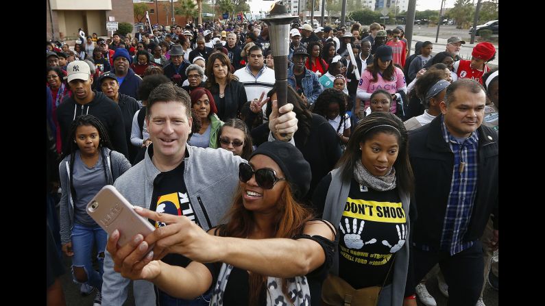 Phoenix Mayor Greg Stanton holds a torch Monday, January 16, during the city's annual march on Martin Luther King Jr. Day.