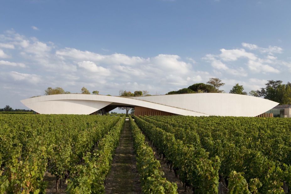 Designed by French architect Christian de Portzamparc, this prestigious cellar rises from a grass hill as if part of the scenery. The curvaceous concrete structure houses a 64,583 square foot cellar stocked with 52 enormous cement vats that range in capacity from 20 to 110 hectoliters.