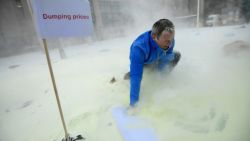 A man walks in milk powder sprayed by European Milk board (EMB) representatives in front of the European Council during a demonstration on the side of a meeting of EU ministers of agriculture, in Brussels, on January, 23, 2017.
Demonstrators protested on January 23 against the European Commission's decision to gradually reinstate withdrawn milk powder stocks, in an attempt to stabilise the price, at the height of a crisis of overproduction. / AFP / EMMANUEL DUNAND        (Photo credit should read EMMANUEL DUNAND/AFP/Getty Images)