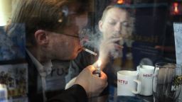 Helsinki, FINLAND: Men smoke cigarettes in a bar in Helsinki 31 May 2007. Finland will become 01 June 2007 the latest European nation to ban smoking in bars and restaurants, a measure that is expected to be introduced fairly painlessly in the tobacco-critical state. AFP PHOTO / LEHTIKUVA / Jussi Nukari  FINLAND OUT (Photo credit should read JUSSI NUKARI/AFP/Getty Images)