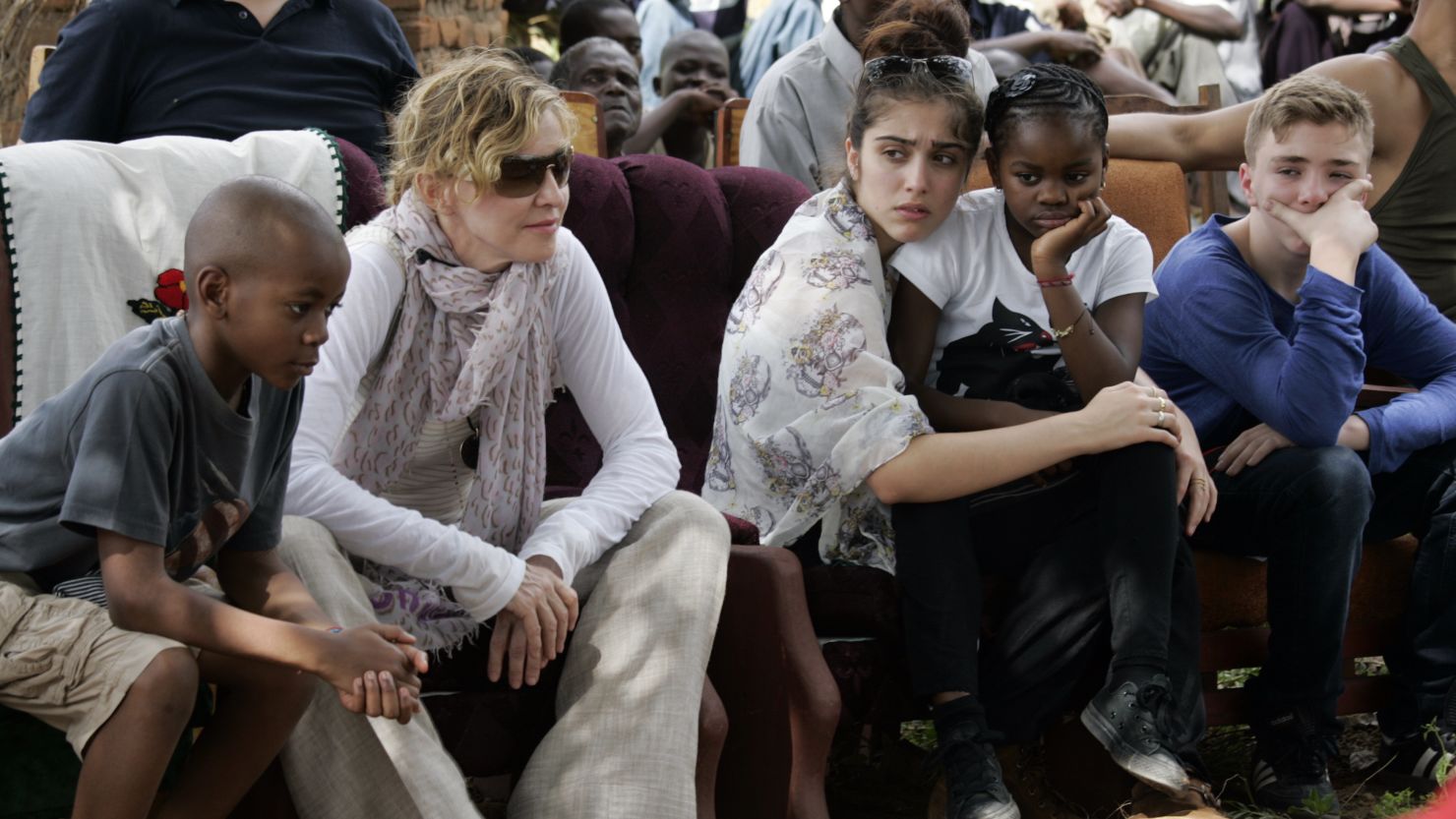 Madonna sits with her children (L to R) David Banda, Lourdes, Mercy James, and Rocco at Mkoko Primary School, one of the schools Madonna's Raising Malawi organization on April 2, 2013.