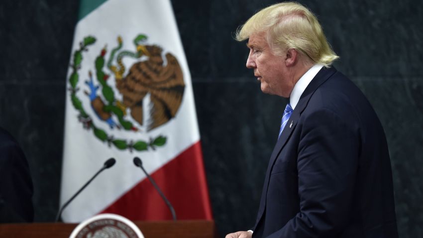 US presidential candidate Donald Trump leaves after a joint press conference with Mexican President Enrique Pena Nieto (out of frame) in Mexico City on August 31, 2016.
Donald Trump was expected in Mexico Wednesday to meet its president, in a move aimed at showing that despite the Republican White House hopeful's hardline opposition to illegal immigration he is no close-minded xenophobe. Trump stunned the political establishment when he announced late Tuesday that he was making the surprise trip south of the border to meet with President Enrique Pena Nieto, a sharp Trump critic.
/ AFP / YURI CORTEZ (Photo credit should read YURI CORTEZ/AFP/Getty Images)
