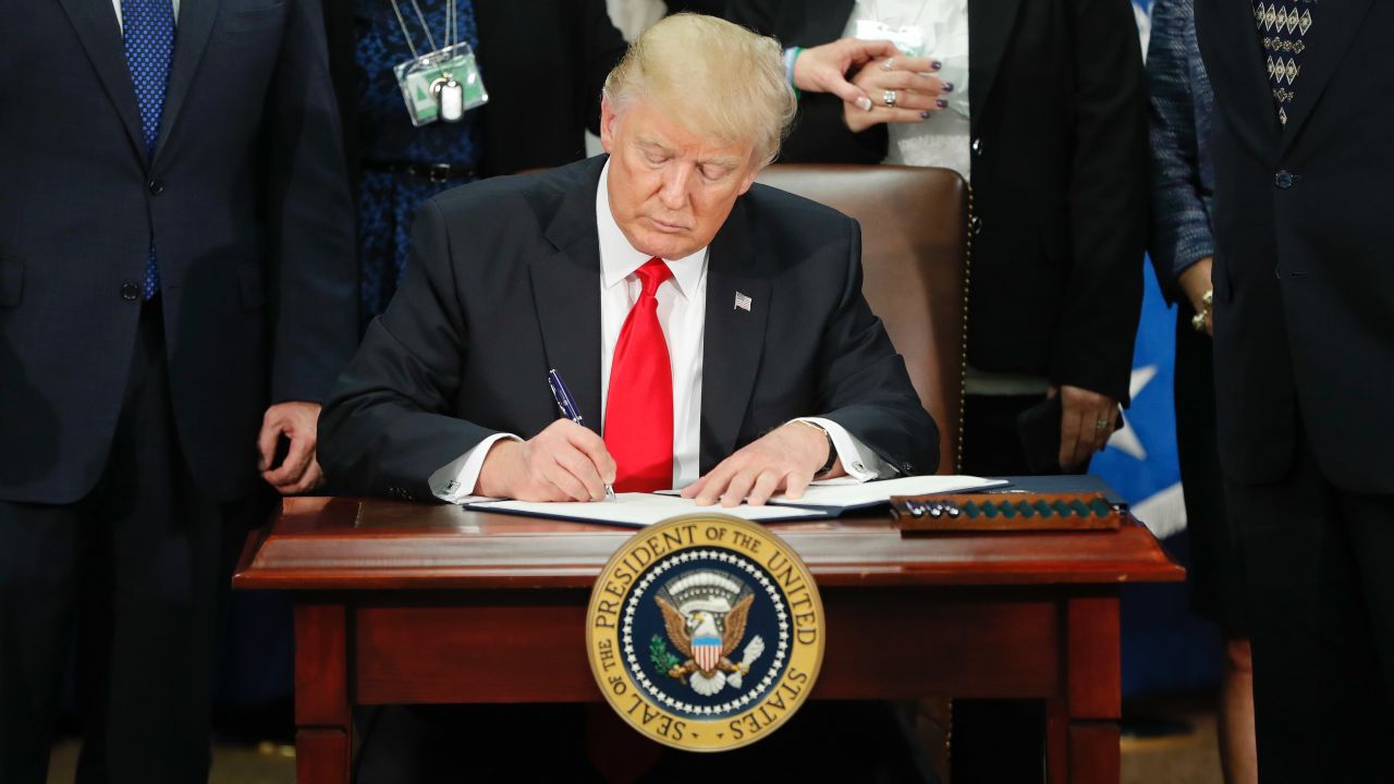 President Donald Trump signs an executive order for border security and immigration enforcement improvements, Wednesday, Jan. 25, 2017, at the Homeland Security Department in Washington. (AP Photo/Pablo Martinez Monsivais)