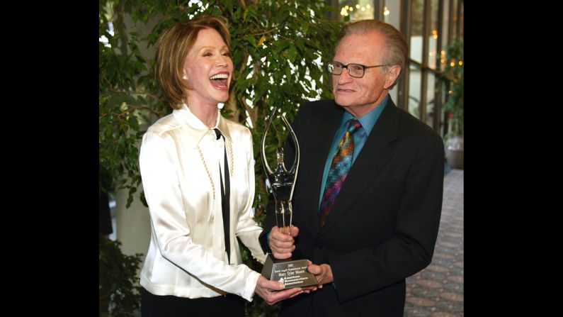 Moore receives the David Angell Humanitarian Award from Larry King in 2002. The award was established by the American Screenwriters Association. Moore suffered from Type 1 diabetes and was chairwoman of the Juvenile Diabetes Research Foundation.