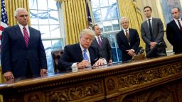 TOPSHOT - US President Donald Trump signs an executive order in the Oval Office of the White House in Washington, DC, January 23, 2017.
Trump on Monday signed three orders on withdrawing the US from the Trans-Pacific Partnership trade deal, freezing the hiring of federal workers and hitting foreign NGOs that help with abortion. / AFP / SAUL LOEB        (Photo credit should read SAUL LOEB/AFP/Getty Images)
