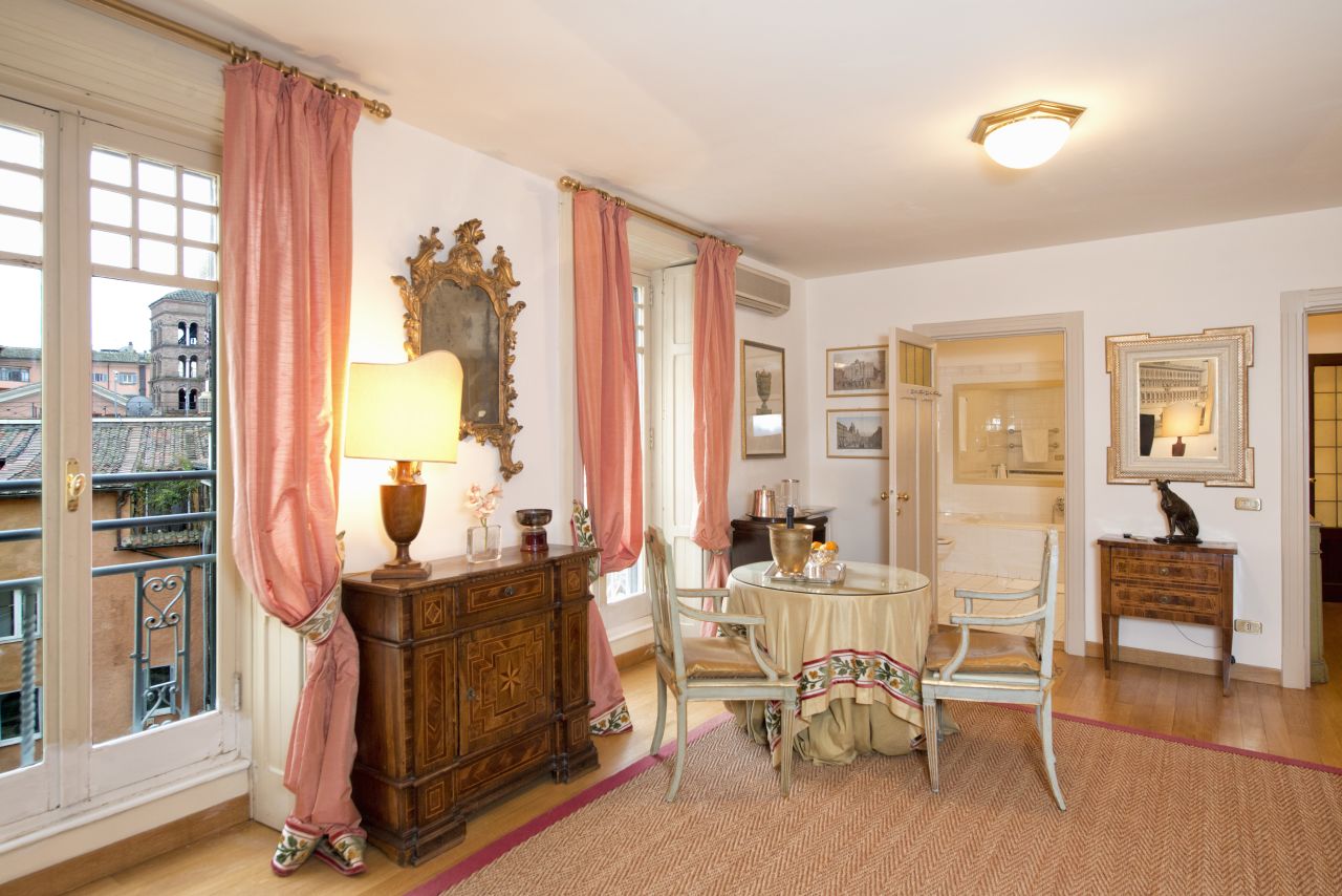 The Princess Pia suite at the Residenza Ruspoli Bonaparte features a living room, a master bedroom, a second bedroom with two single beds and two private bathrooms.