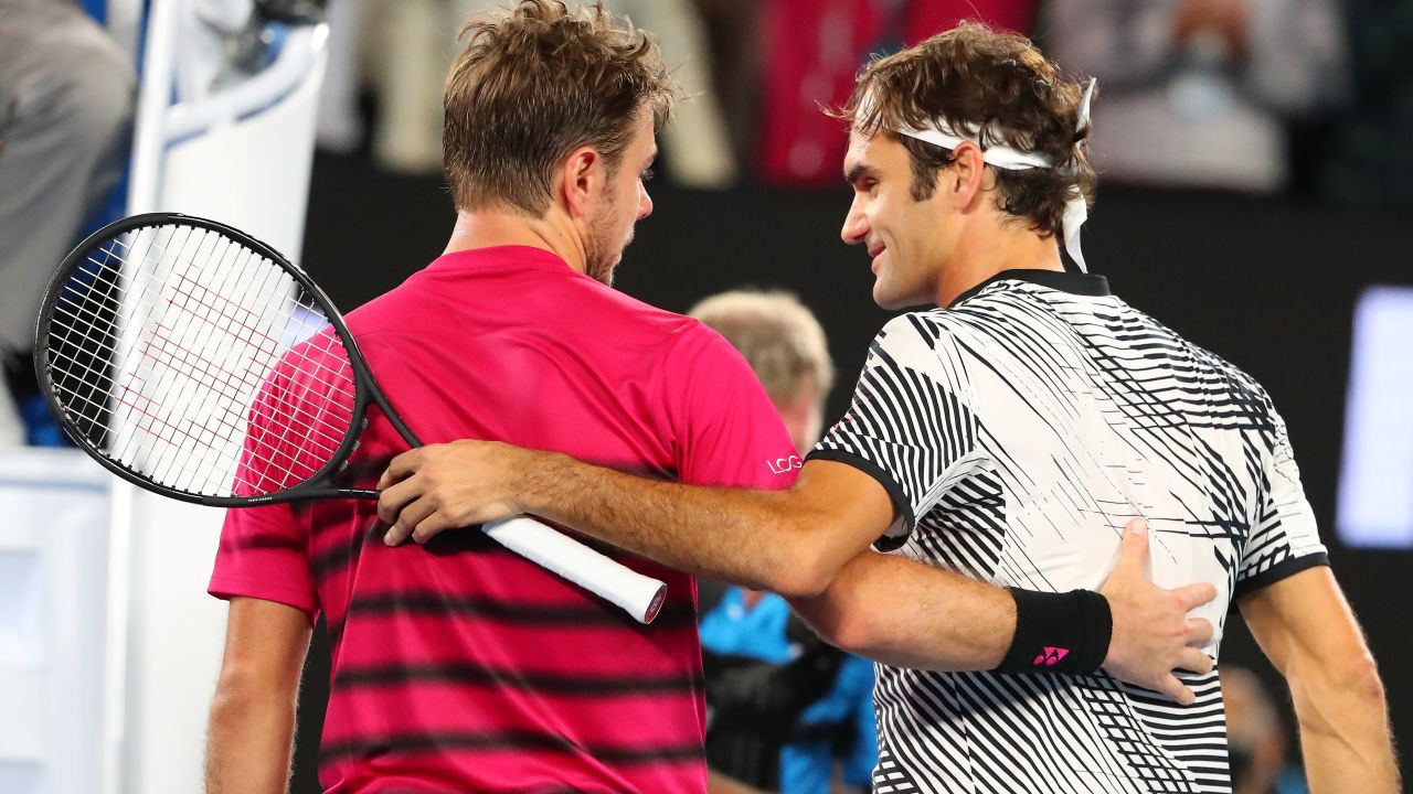 Stan Wawrinka of Switzerland congratulates Roger Federer of Switzerland.  