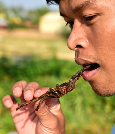 <strong>Crispy outside, soft inside</strong><strong>:</strong><strong> </strong>Cambodian guide Yin Lucky takes a bite. He says the body is the best part. 