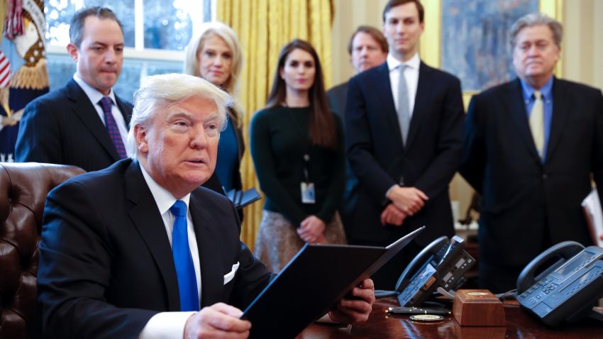 WASHINGTON, DC - JANUARY 24: President Donald Trump signs one of five executive orders related to the oil pipeline industry in the Oval Office of the White House January 24, 2017 in Washington, DC. Looking on are White House Chief of Staff Reince Priebus, counselor to the President Kellyanne Conway, White House Communications Director Hope Hicks, Senior Advisor Jared Kushner (2nd R) and Senior Counselor Stephen Bannon (R). (Photo by Shawn Thew-Pool/Getty Images)