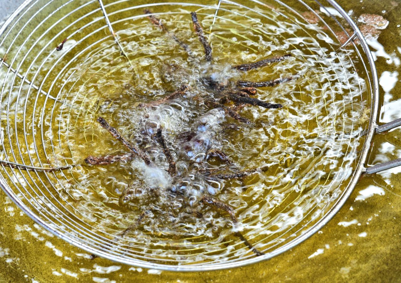 <strong>Fry time:</strong> Once the spiders are well soaked, they're placed in the wok's boiling oil for no more than 45 seconds, says cooking teacher Ouch Ratana.  