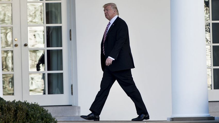 President Donald Trump walks from the Residence to the West Wing of the White House after returning from Philadelphia on January 26, 2017 in Washington, DC.