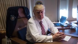 US President Donald Trump poses in his office aboard Air Force One at Andrews Air Force Base in Maryland after he returned from Philadelphia on January 26, 2017. / AFP / NICHOLAS KAMM        (Photo credit should read NICHOLAS KAMM/AFP/Getty Images)