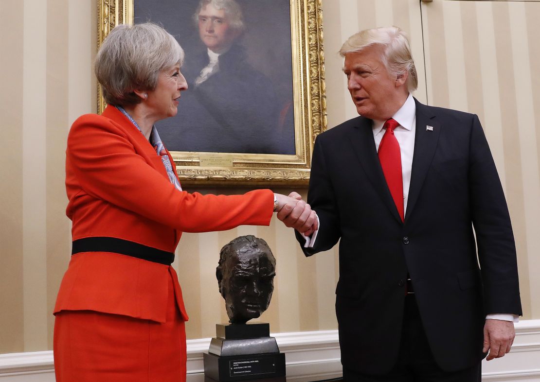 President Donald Trump shakes hands with British Prime Minister Theresa May in the Oval Office of the White House in Washington.