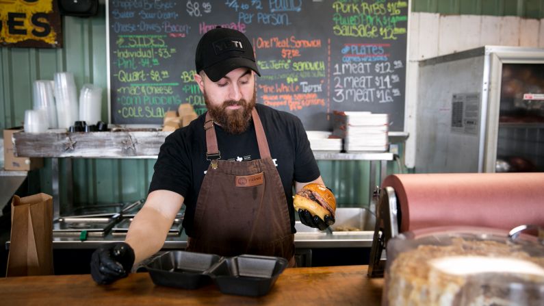 Leonard Botello, owner of Truth BBQ in Brenham, Texas, boxes up a brisket sandwich. Brenham is about halfway between Houston and Austin in Washington County.