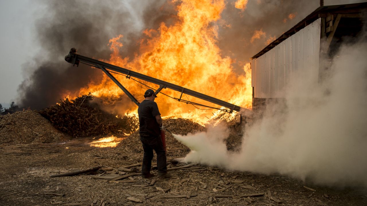 Men work to put out a raging fire in Constitucion, about 220 miles south of Santiago, the capital. 