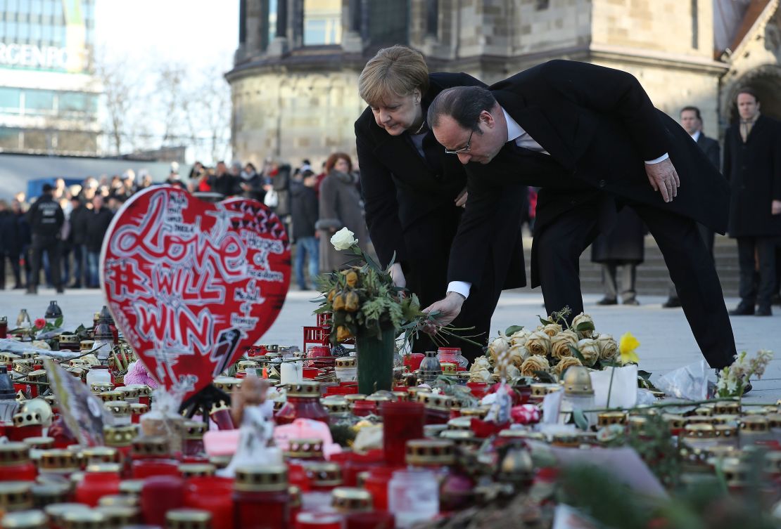 Merkel and Hollande lay flowers Friday at a memorial to the victims of the December Berlin terror attack.