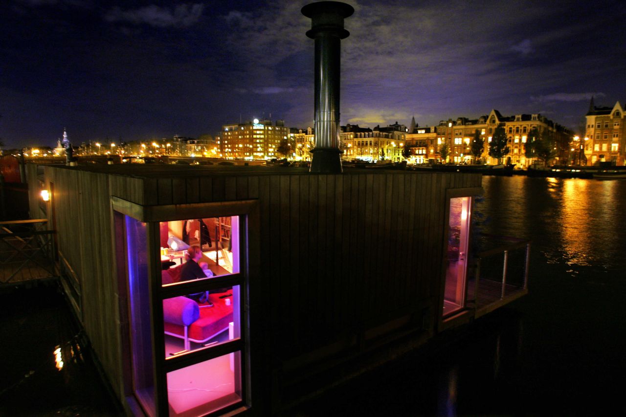 The view from the canal is equally spectacular at night -- here, a houseboat is pictured.