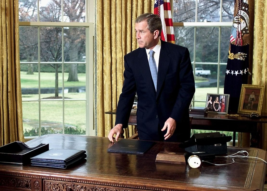 President George W. Bush gets up from his desk in the Oval Office of the White House after finishing a call to former First Lady Nancy Reagan on the occasion of former US President Ronald Reagan's 90th birthday 15 February, 2001 in Washington, DC..