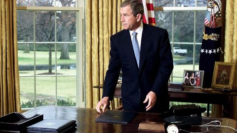 President George W. Bush gets up from his desk in the Oval Office of the White House after finishing a call to former First Lady Nancy Reagan on the occasion of former US President Ronald Reagan's 90th birthday 15 February, 2001 in Washington, DC..