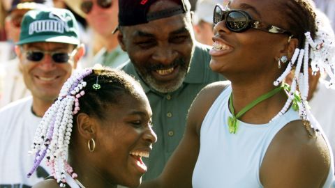 Serena celebrates her Evert Cup final victory over Steffi Graf in 1999 with her sister Venus and her father Richard.