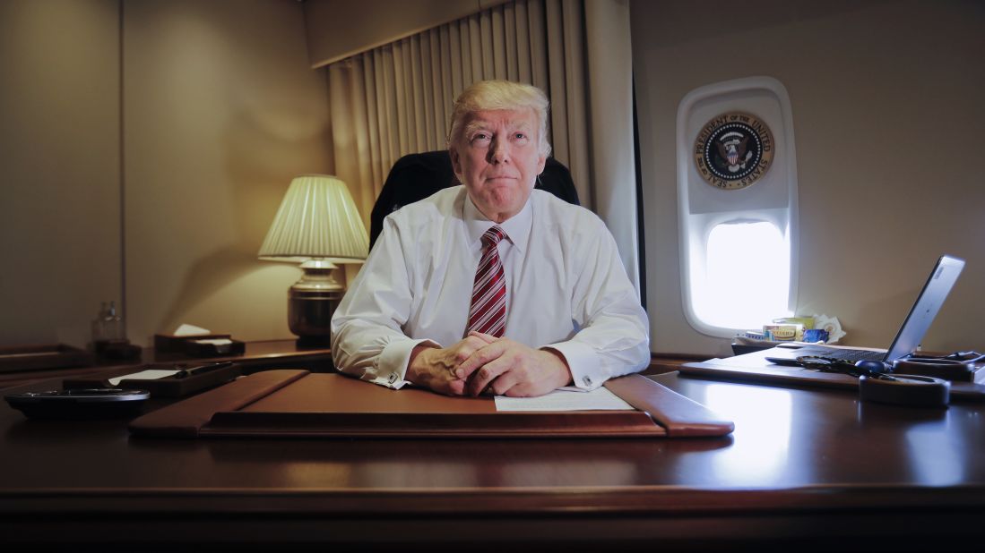 Trump sits at his desk on Air Force One after arriving at Andrews Air Force Base in Maryland on Thursday, January 26.