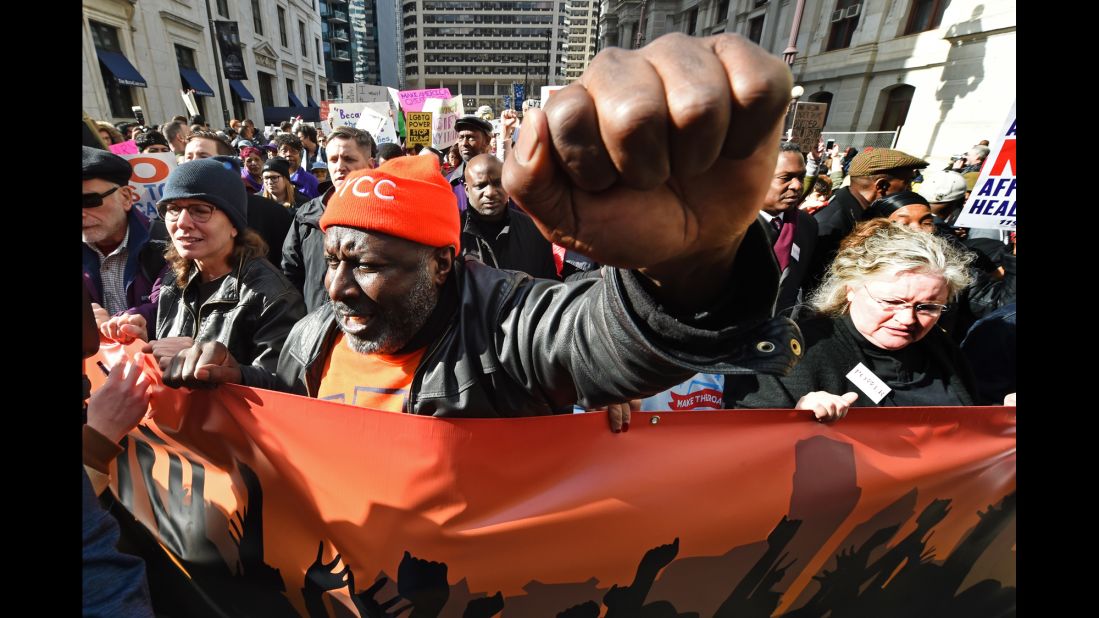 Activists protest as Trump attends a Republican retreat in Philadelphia on Thursday, January 26.