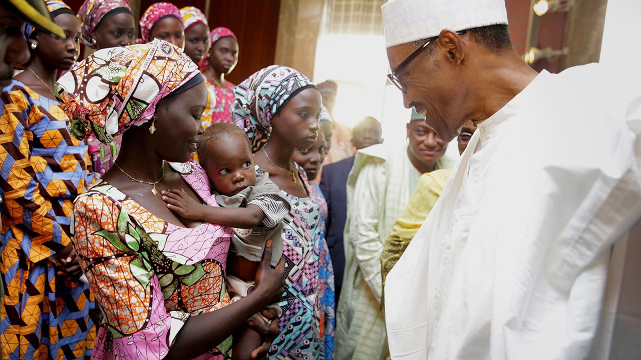 Buhari meets with Chibok schoolgirls during their visit to the presidential villa in Abuja, Nigeria, in October 2016. Boko Haram militants <a href="https://www.cnn.com/2016/10/13/africa/nigeria-chibok-girls-released/index.html" target="_blank">handed over 21 schoolgirls to authorities</a> after a series of negotiations, Nigeria's government said. It was the first mass release of any of the girls who were kidnapped from their school in 2014.