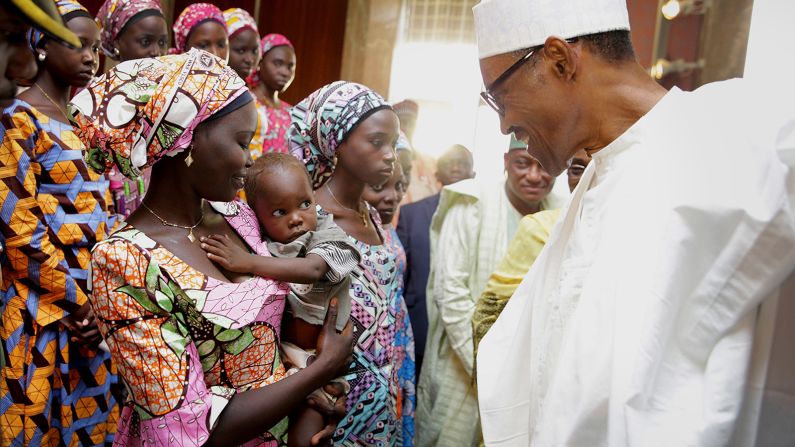 Buhari meets with Chibok schoolgirls during their visit to the presidential villa in Abuja, Nigeria, in October 2016. Boko Haram militants <a href="https://www.cnn.com/2016/10/13/africa/nigeria-chibok-girls-released/index.html" target="_blank">handed over 21 schoolgirls to authorities</a> after a series of negotiations, Nigeria's government said. It was the first mass release of any of the girls who were kidnapped from their school in 2014.