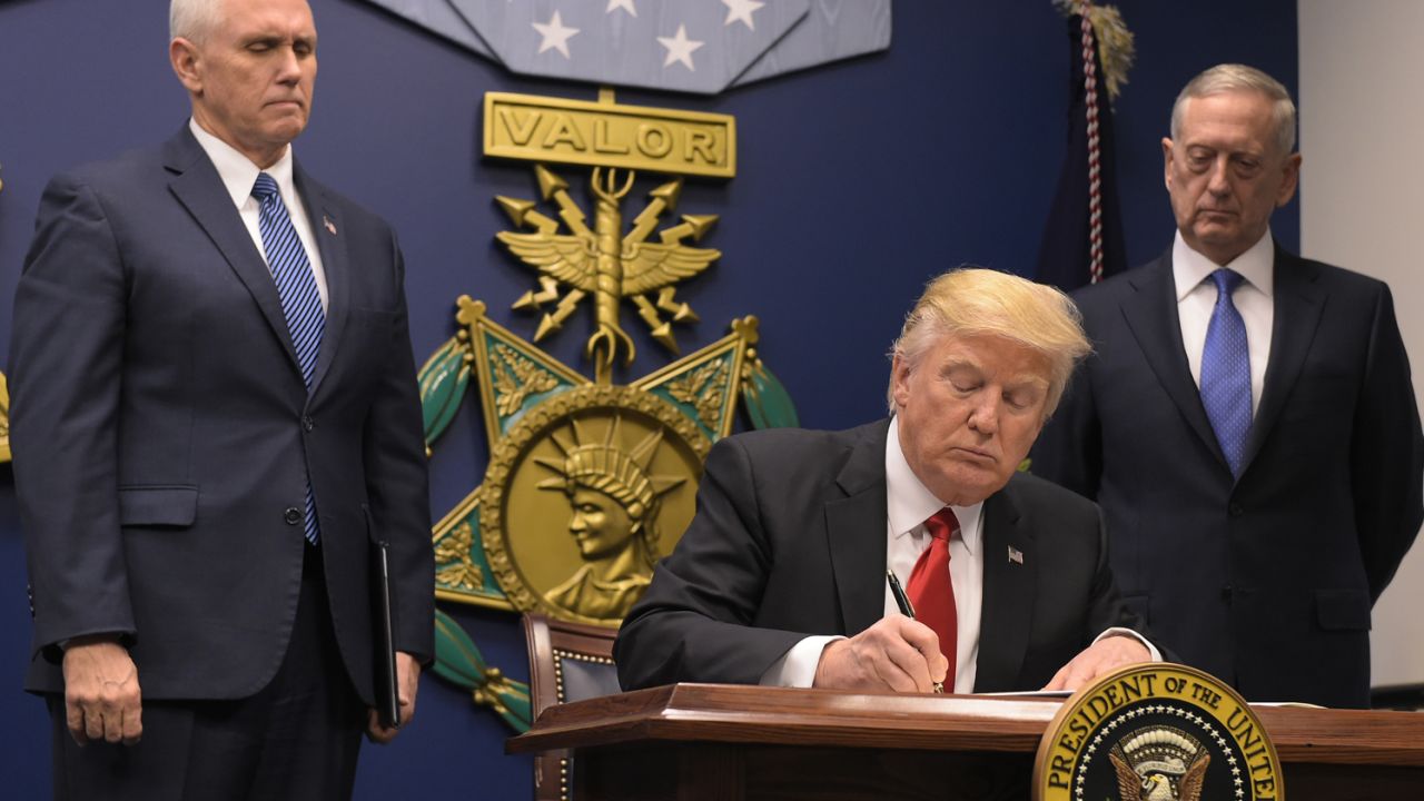 US President Donald Trump signs an executive order alongside US Defense Secretary James Mattis and US Vice President Muike Pence on January 27, 2016 at the Pentagon in Washington, DC.
Trump signed an order Friday to begin what he called a "great rebuilding" of the US armed services, promising new aircraft, naval ships and more resources for the military. "Our military strength will be questioned by no one, but neither will our dedication to peace. We do want peace," Trump said in a ceremony at the Pentagon.
 / AFP / MANDEL NGAN        (Photo credit should read MANDEL NGAN/AFP/Getty Images)