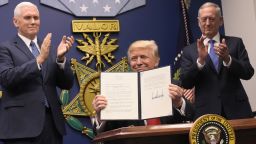 US President Donald Trump holds up an executive action on rebuilding the armed forces after signing it on January 27, 2017 at the Pentagon in Washington, DC. Looking on are US Vice President Mike Pence (L) and US Defense Secretary James Mattis. / AFP / MANDEL NGAN        (Photo credit should read MANDEL NGAN/AFP/Getty Images)