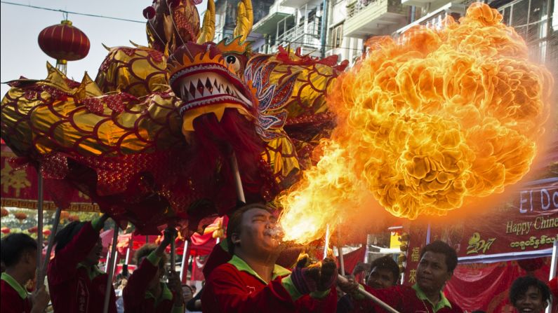A fire-breathing man shows up the dragon behind him in Yangon, Myanmar. 